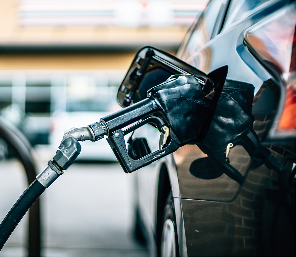 A fuel nozzle inserted into a car, pumping gas
